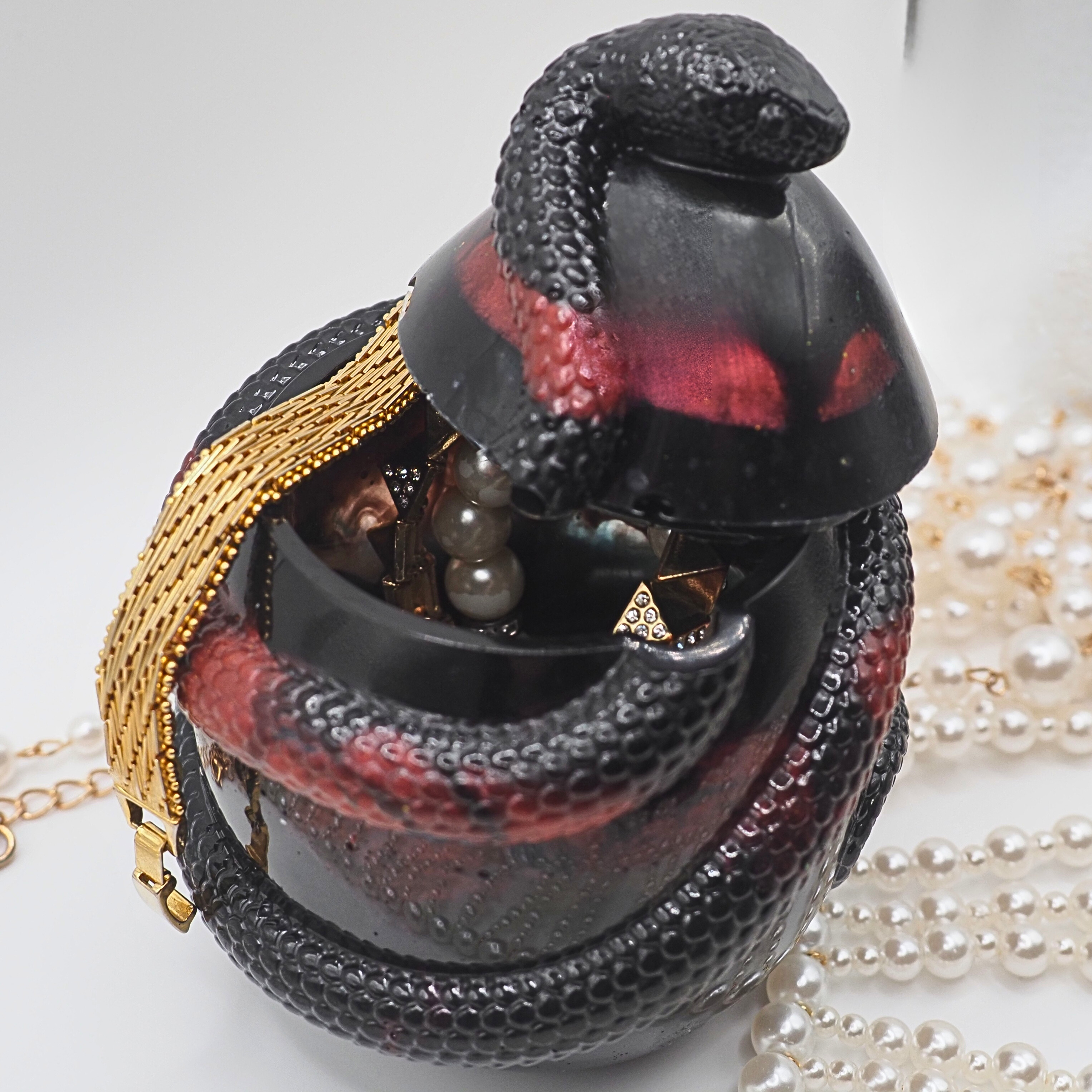  Eclipse Coil Reliquary a black and red resin snake jar 
