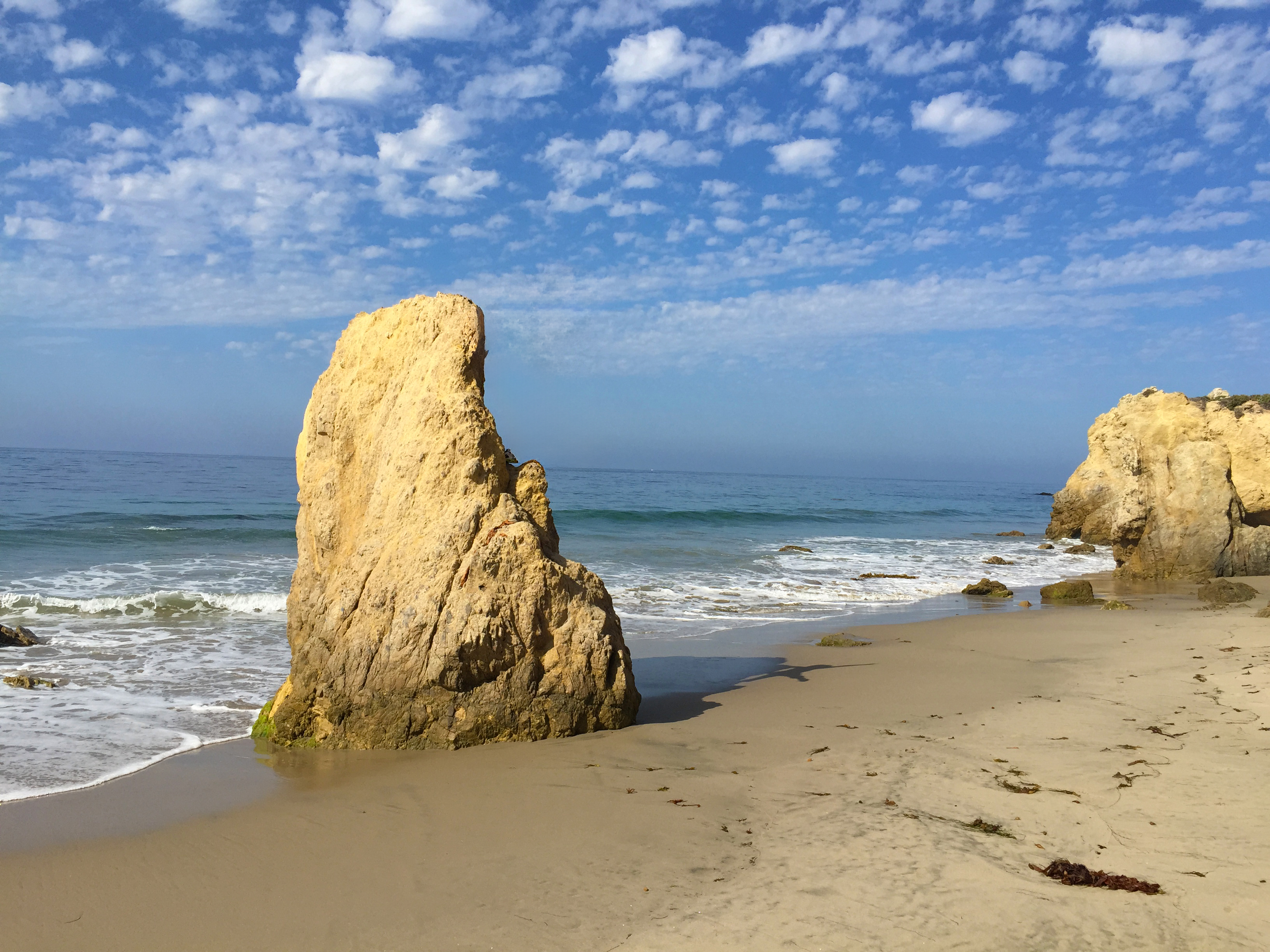  Coastal monolith tall golden rock on a quiet beach