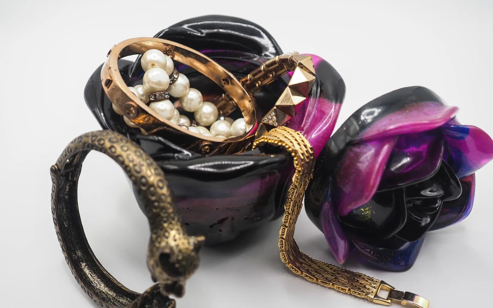 Handmade resin object styled with jewelry and sculptural forms